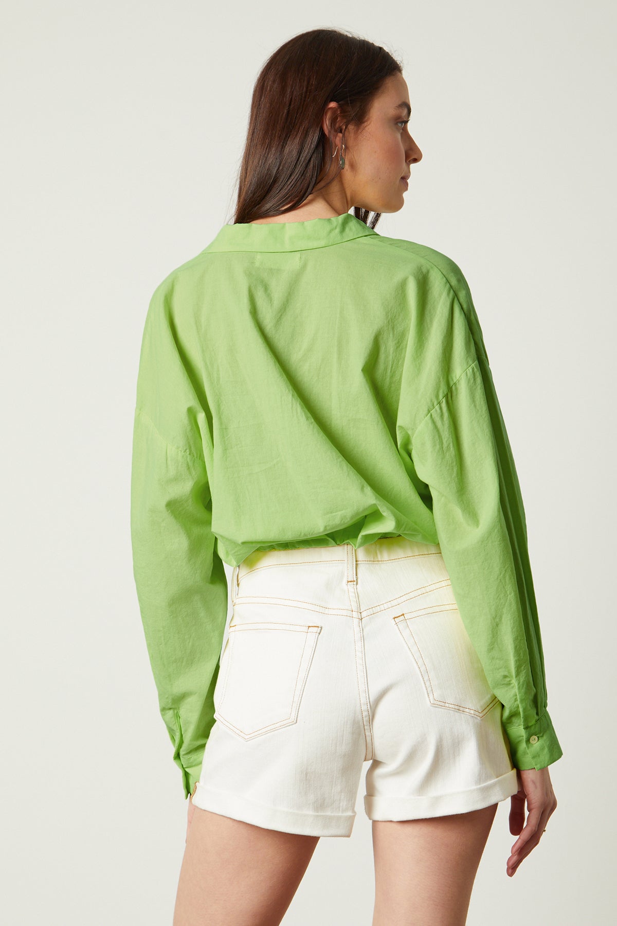   The back view of a woman wearing a Velvet by Graham & Spencer JULIA BUTTON-UP CROPPED SHIRT during the weekend. 