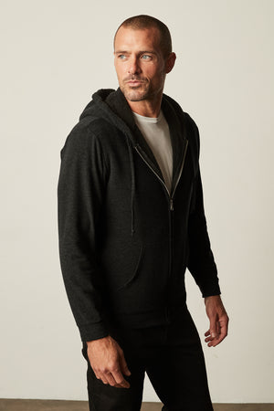 A man wearing a Velvet by Graham & Spencer SALVADORE SHERPA LINED HOODIE
