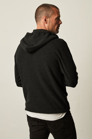 The back of a man wearing a Velvet by Graham & Spencer SALVADORE SHERPA LINED HOODIE with an adjustable drawstring hood.