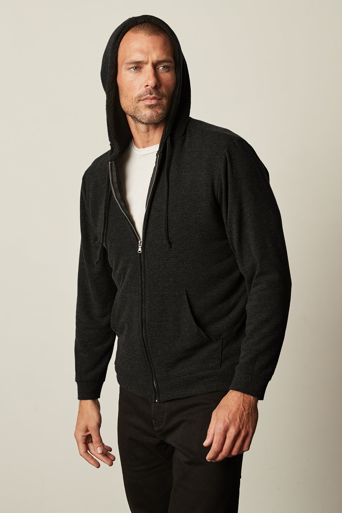 A man wearing a Velvet by Graham & Spencer SALVADORE SHERPA LINED HOODIE with an adjustable drawstring hood.-25484071207105