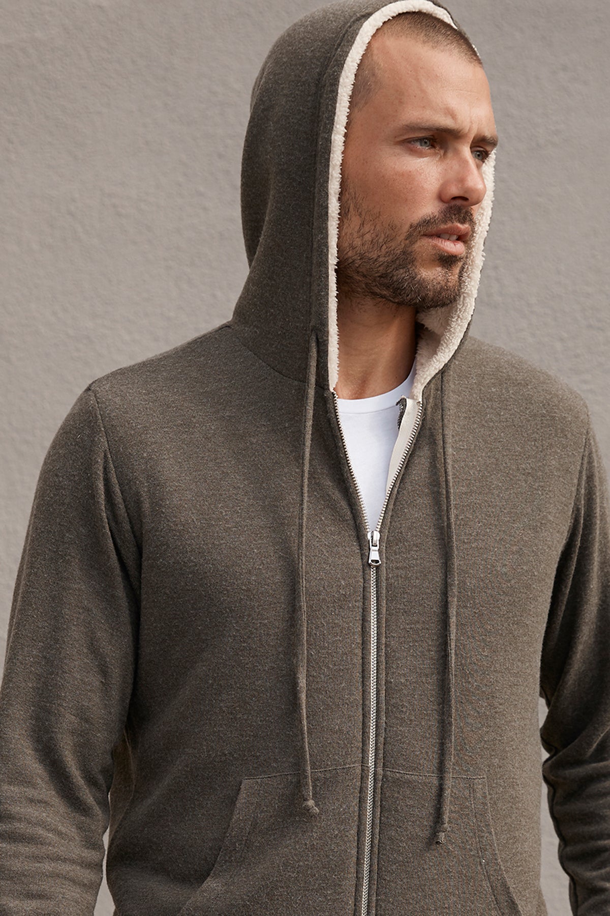   A man wearing a Velvet by Graham & Spencer SALVADORE SHERPA LINED HOODIE. 