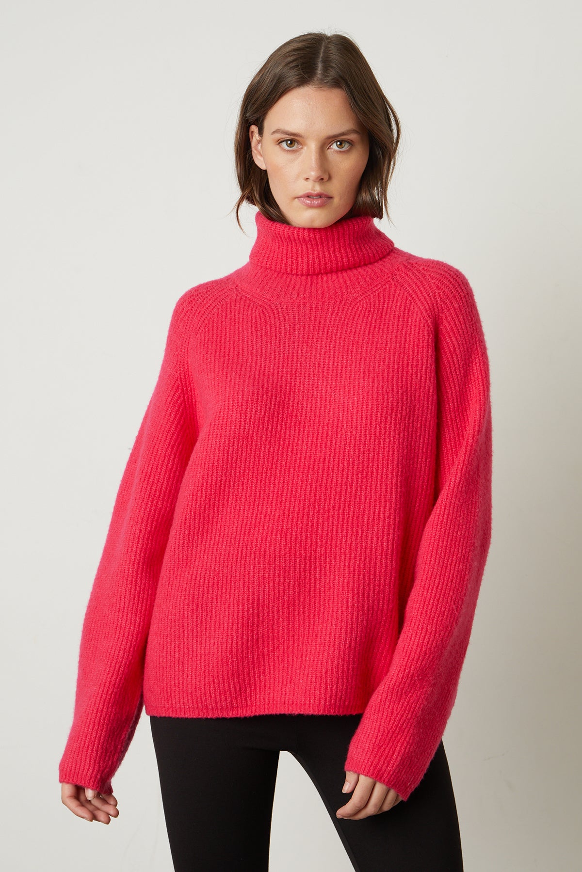 a woman wearing a pink Velvet by Graham & Spencer JUDITH TURTLENECK SWEATER.-25548630622401