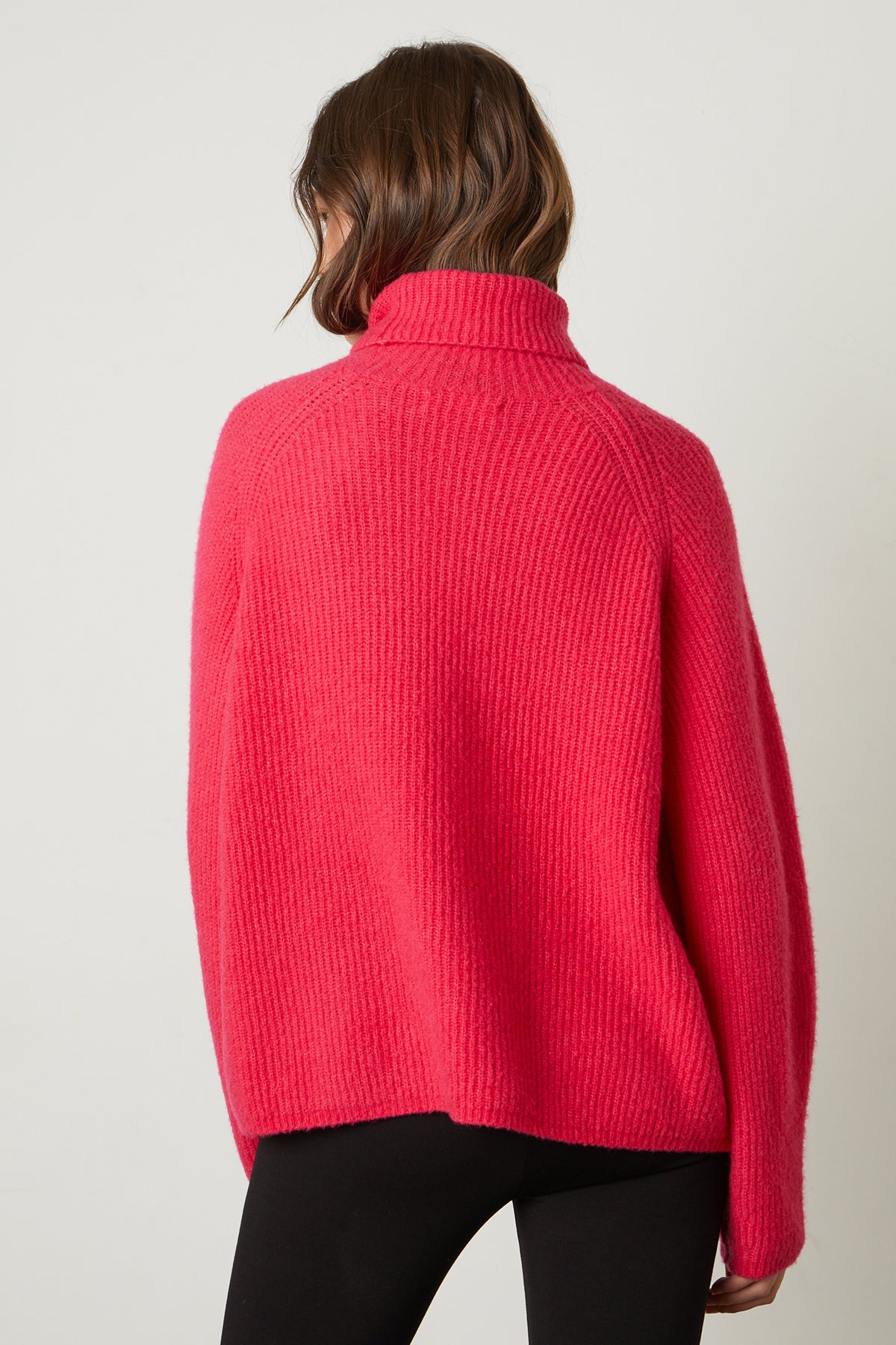 the back view of a woman wearing a Velvet by Graham & Spencer JUDITH turtleneck sweater.-25548630655169