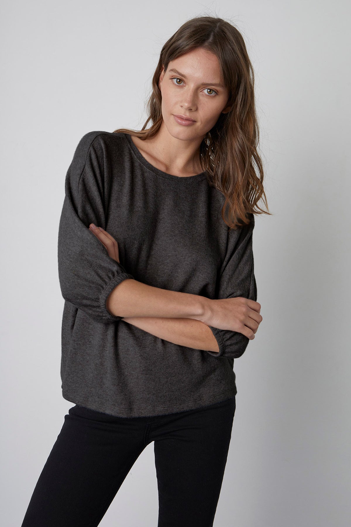   Makayla Crew Neck Pullover in anthracite dark grey front, model standing with folded arms. 
