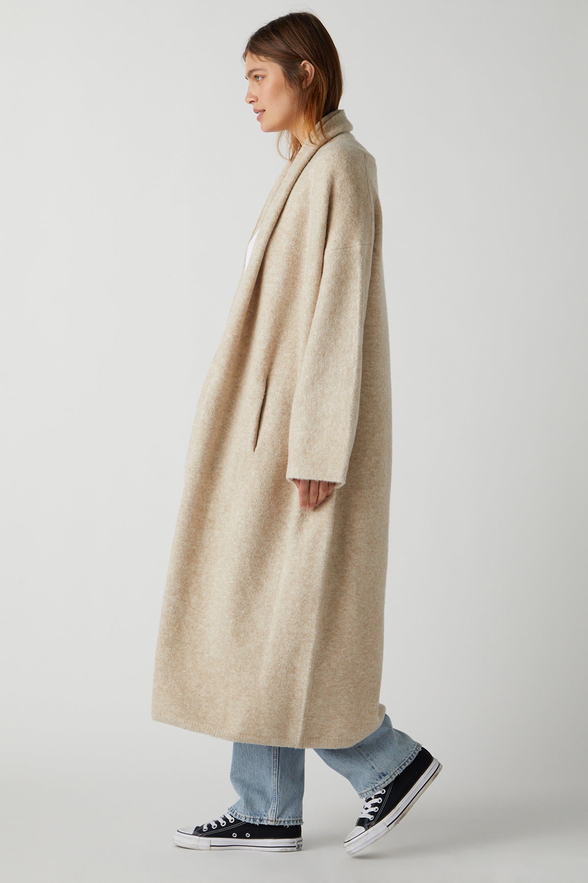 A woman wearing a Velvet by Jenny Graham CARMEL COAT in beige.-25483375706305