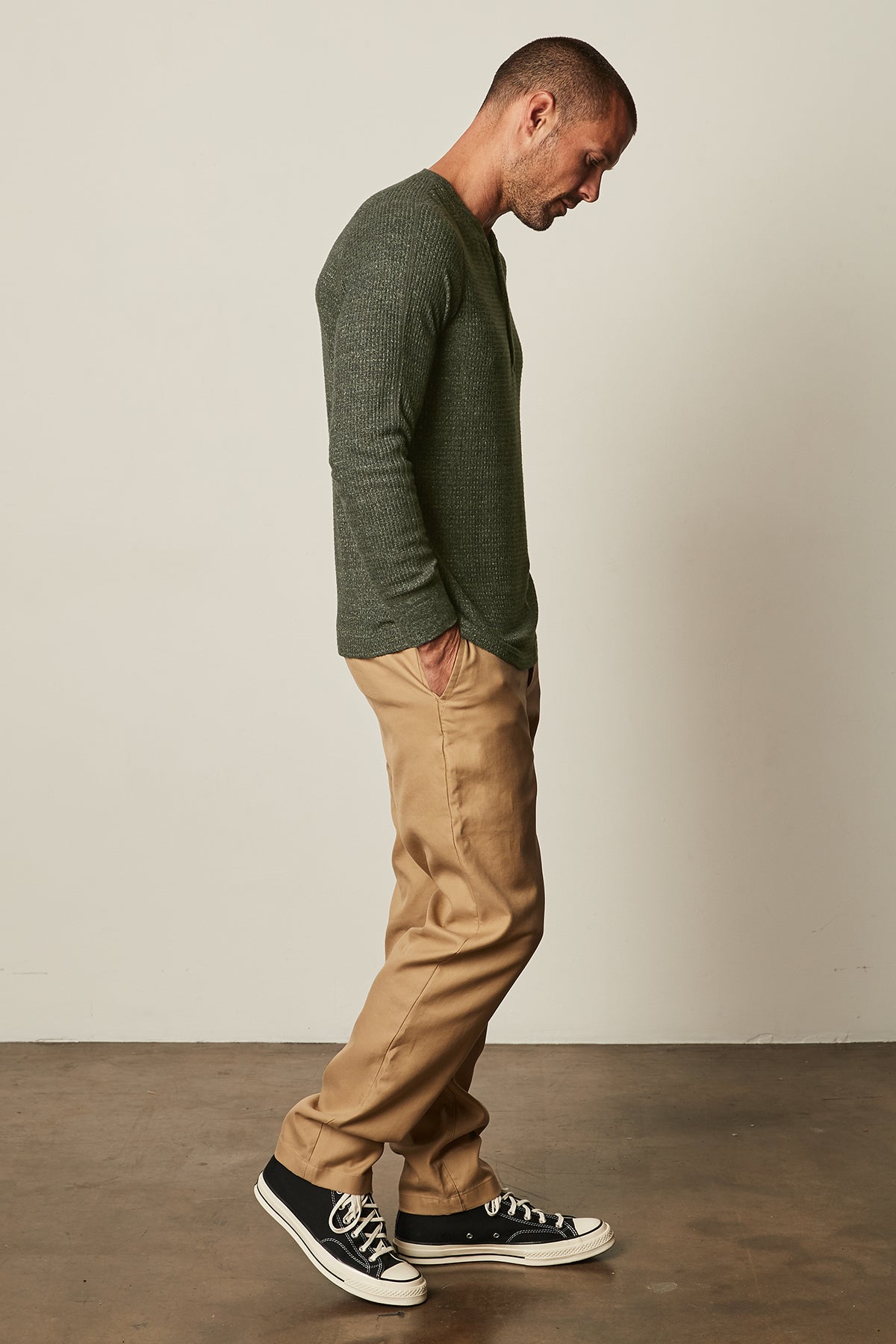   Model standing to the side wearing Anthony Thermal Henley in moss green with Aiden pant in khaki full length view 