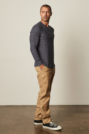 Model standing wearing Anthony Thermal Henley in moss green with Aiden pant in khaki full length side & front view