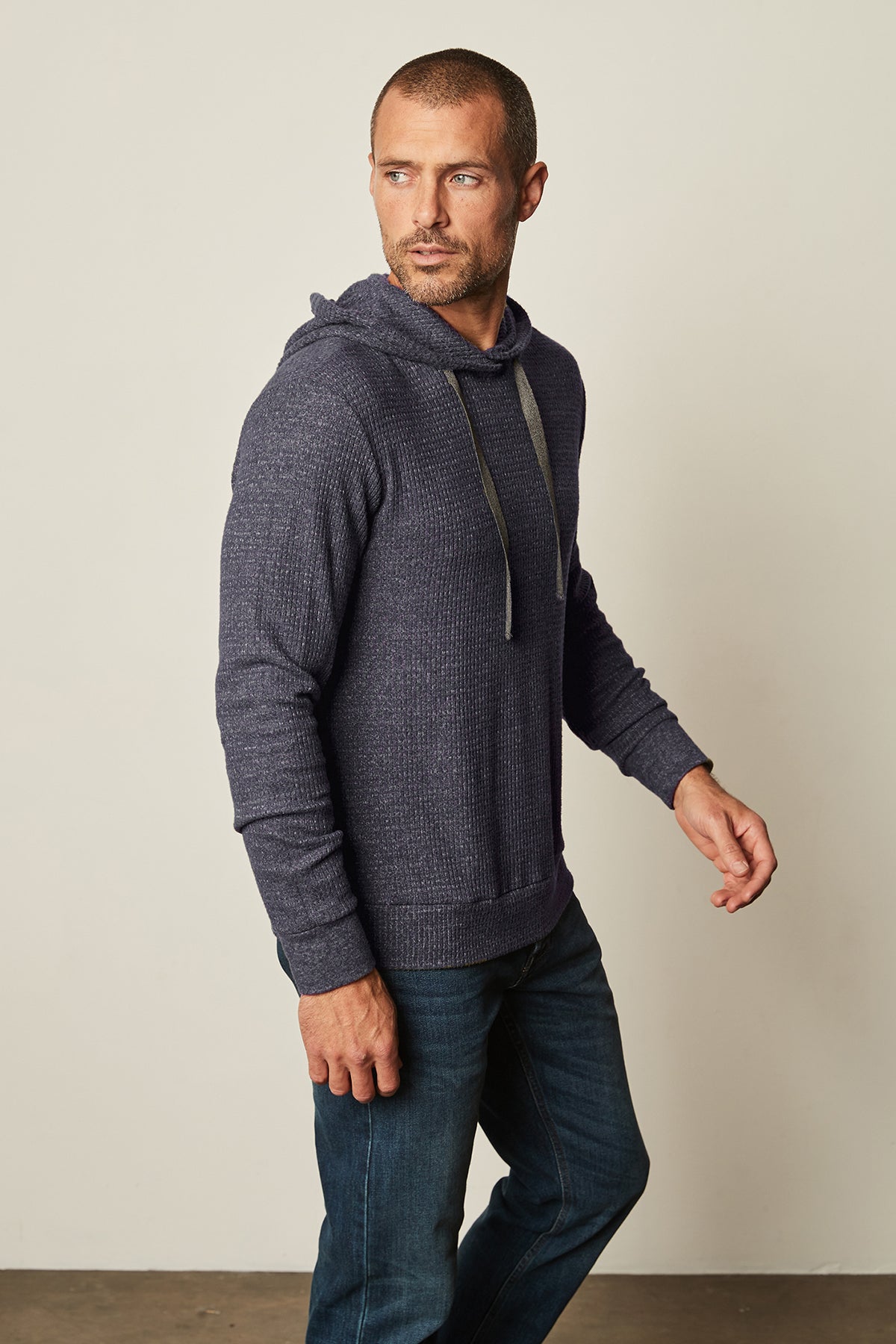A man wearing jeans and a Velvet by Graham & Spencer COLIN THERMAL HOODIE.-25483883217089