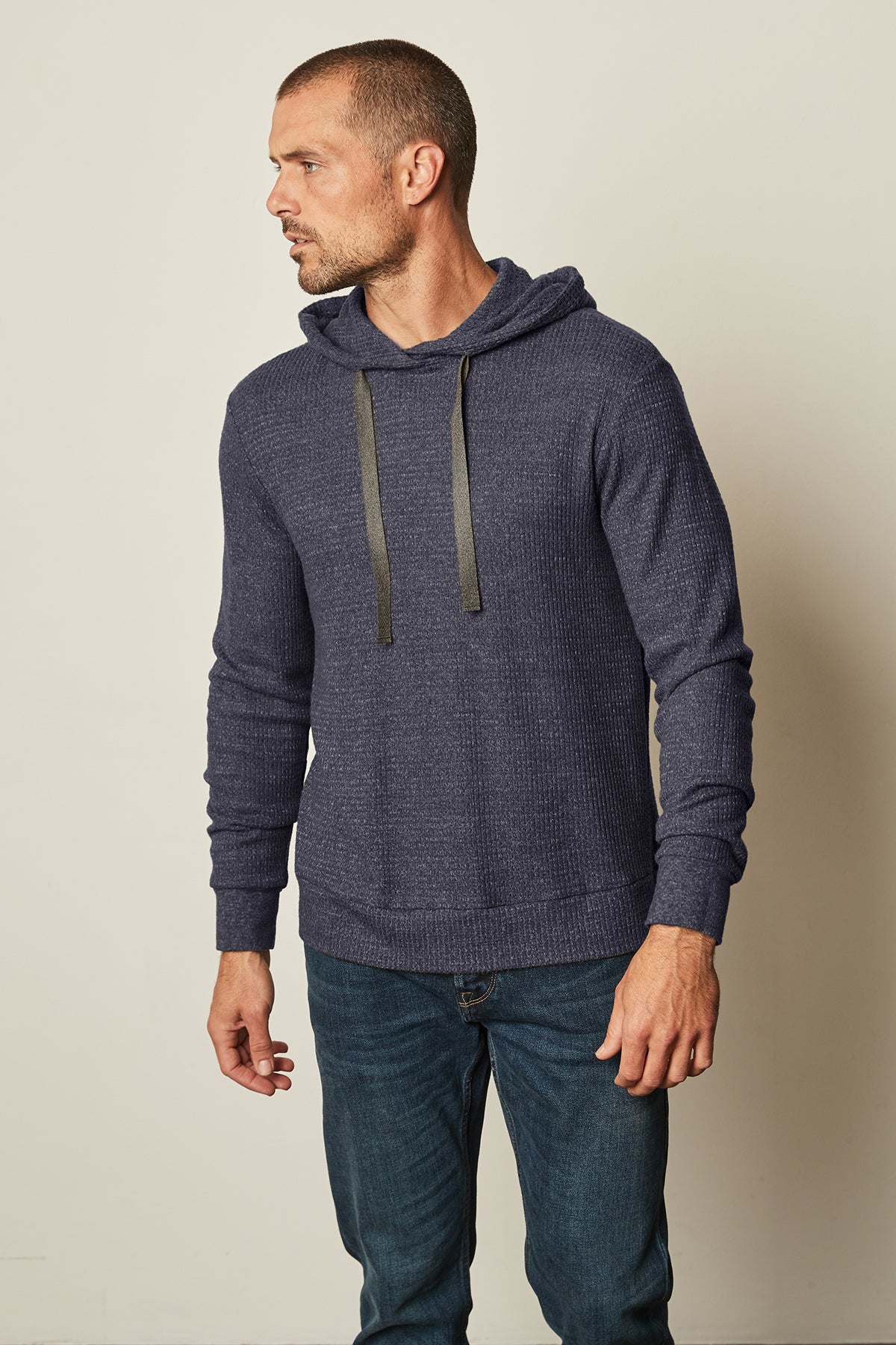   A man wearing a Velvet by Graham & Spencer COLIN THERMAL HOODIE and jeans. 