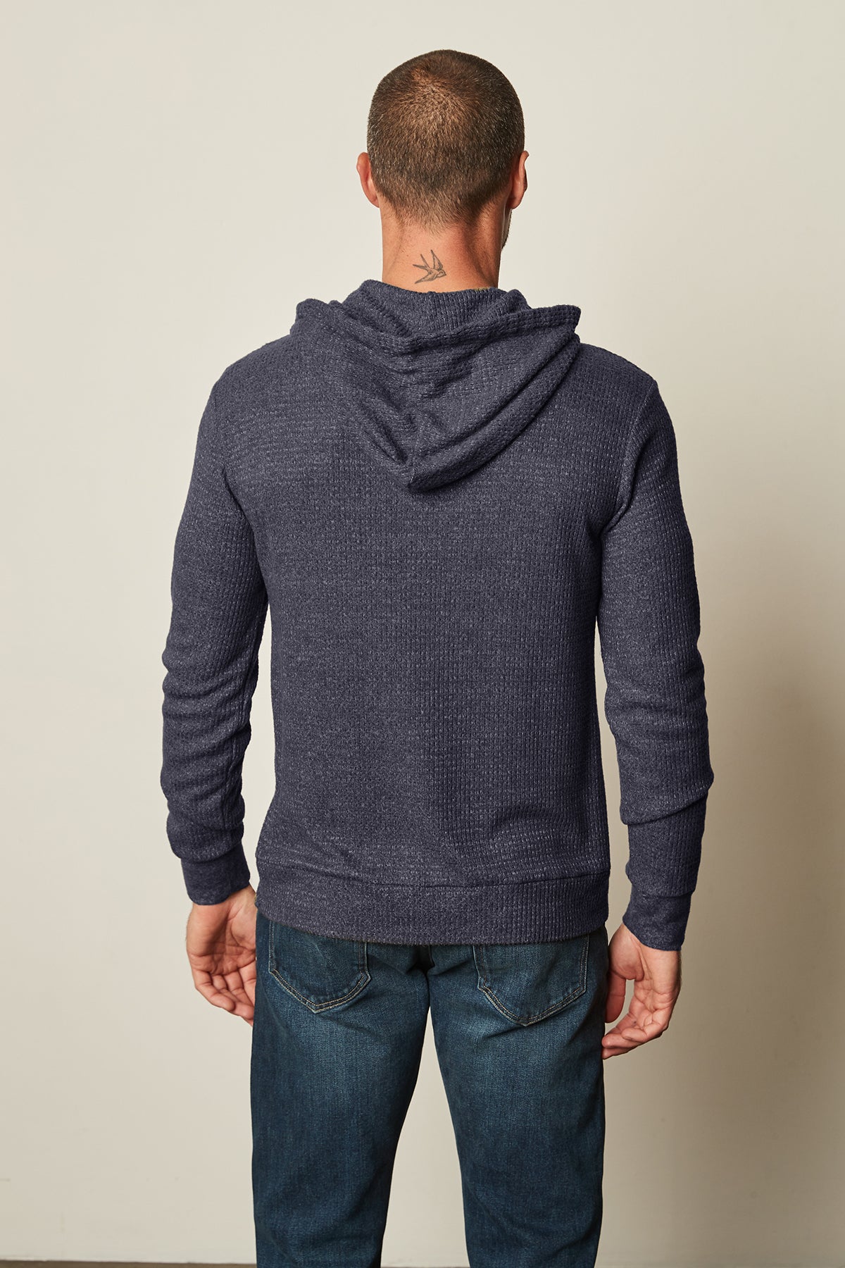   The back view of a man wearing navy jeans and a Velvet by Graham & Spencer COLIN THERMAL HOODIE. 