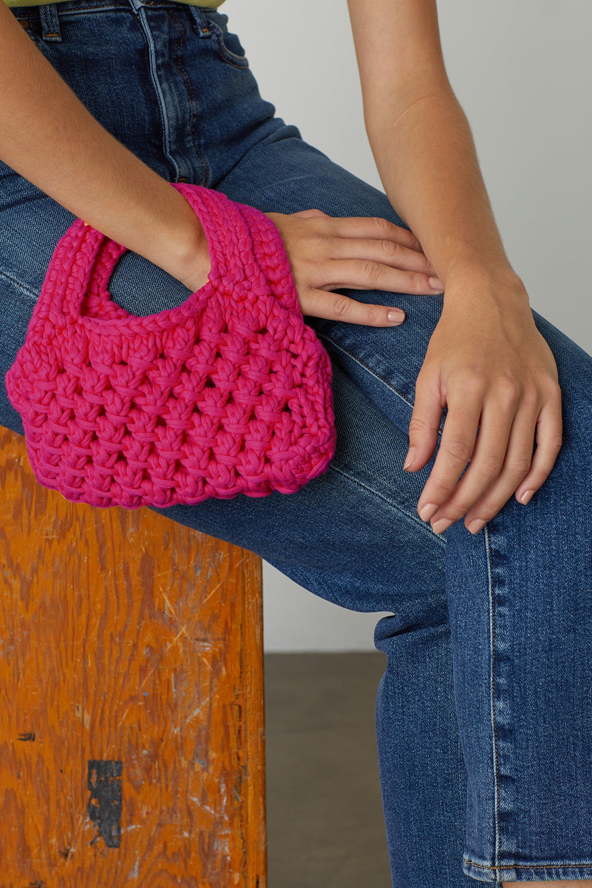   Bennie Crochet Bag in magenta pink on model's wrist 