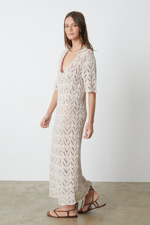 Jacqueline Crochet Stitch Maxi Dress in putty with brown sandals full length side