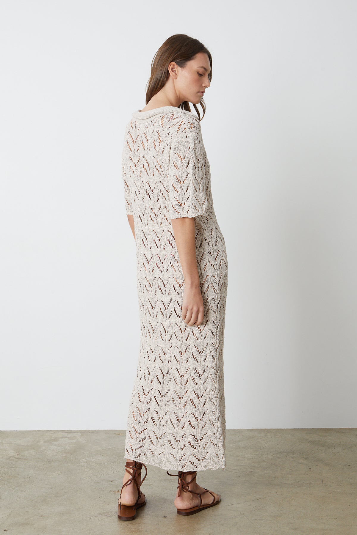 Jacqueline Crochet Stitch Maxi Dress in putty with brown sandals full length back, woman standing with head over shoulder-26296066834625