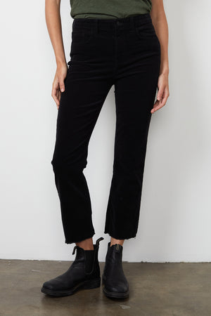 A woman wearing Velvet by Graham & Spencer CANDACE CORDUROY HIGH RISE CROP JEAN with a cropped cuff.