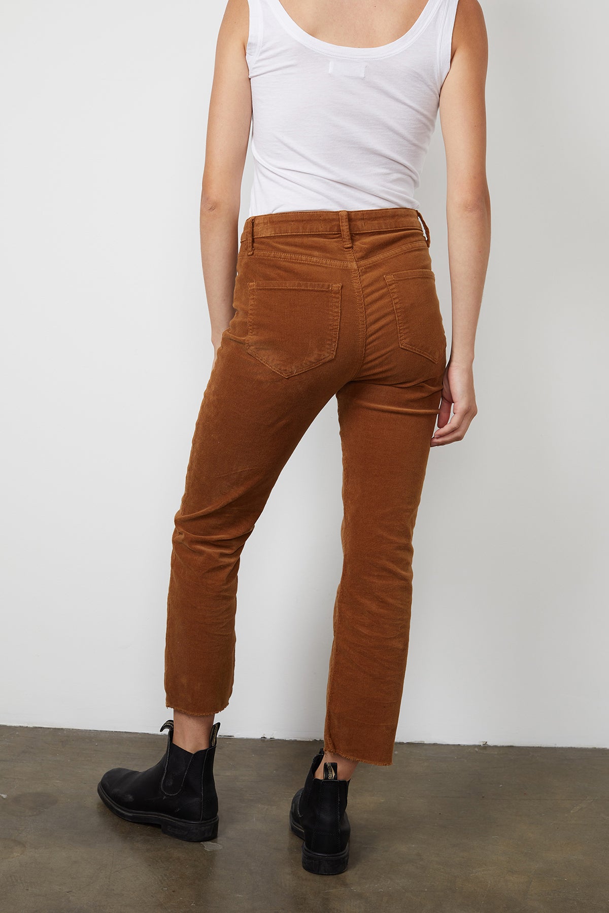   The back view of a person wearing Velvet by Graham & Spencer's CANDACE CORDUROY HIGH RISE CROP JEAN. 