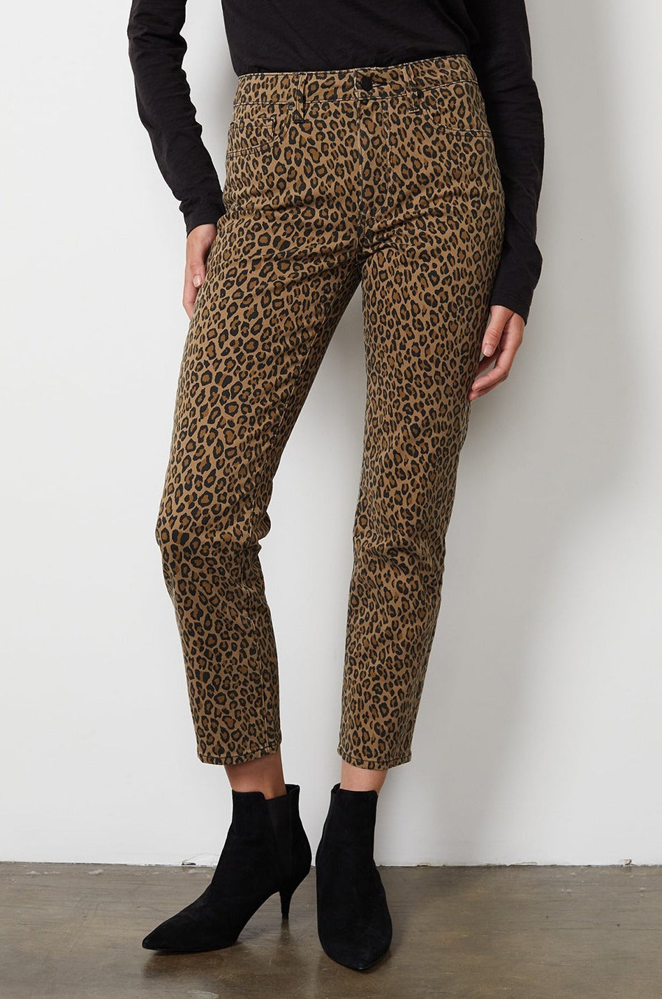   A woman wearing leopard print pants and Velvet by Graham & Spencer CHANELL STRAIGHT LEG DENIM. 