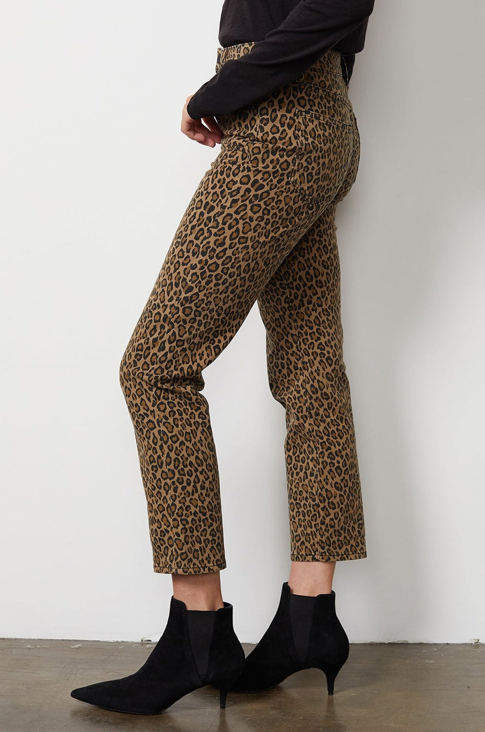 A woman wearing Velvet by Graham & Spencer leopard print pants and winter boots.-16675719217345