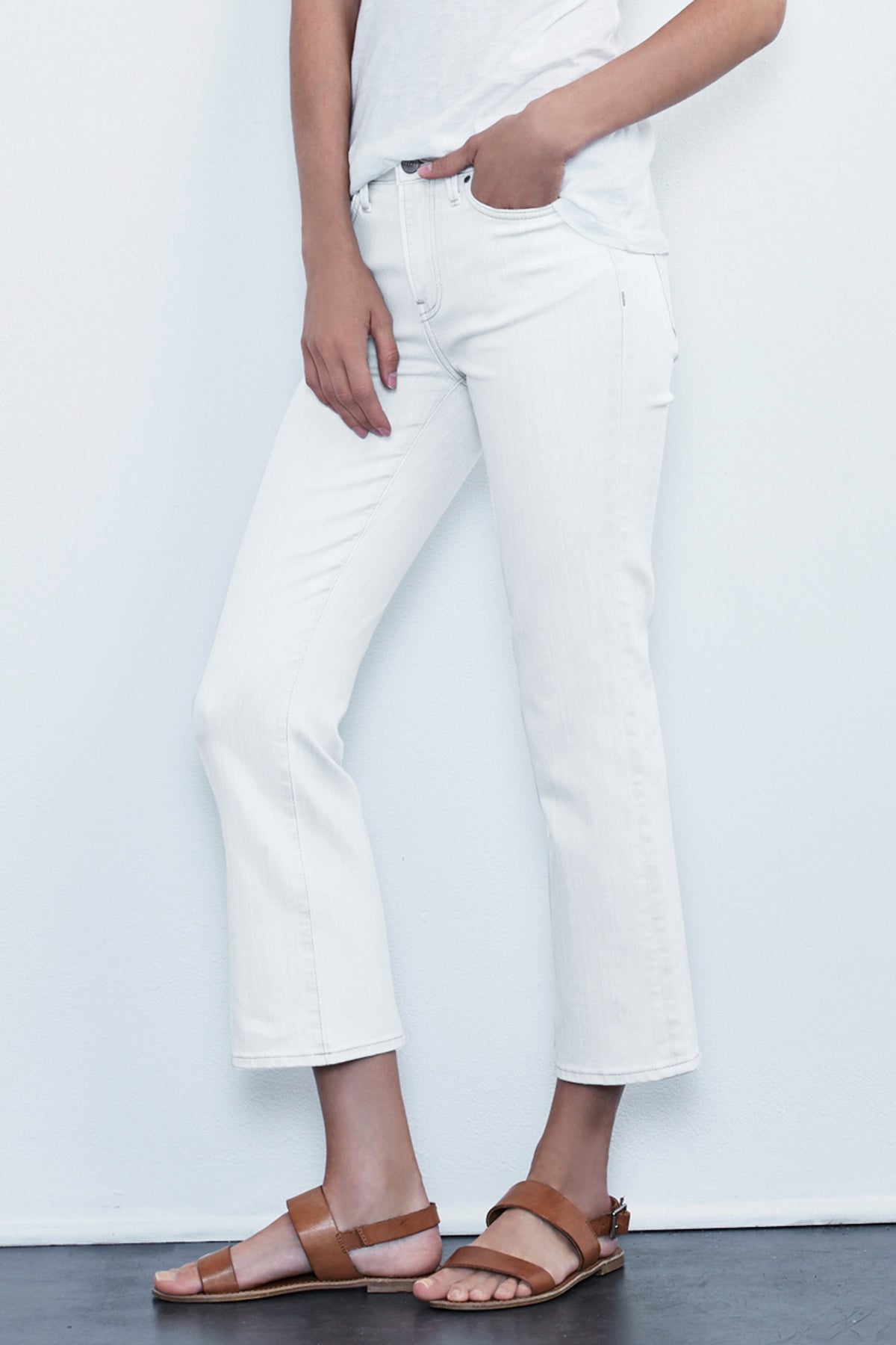   A woman wearing Velvet by Graham & Spencer's KATE HIGH RISE CROP JEAN with a stretch waistline. 
