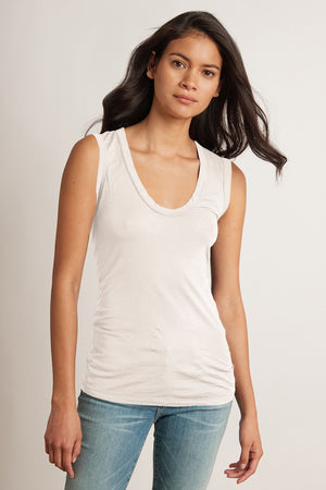 A woman wearing a laid-back Velvet by Graham & Spencer ESTINA GAUZY WHISPER FITTED TANK TOP.