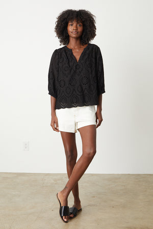 Quinn Top in black eyelet with Natalie white denim shorts and black slides full length front