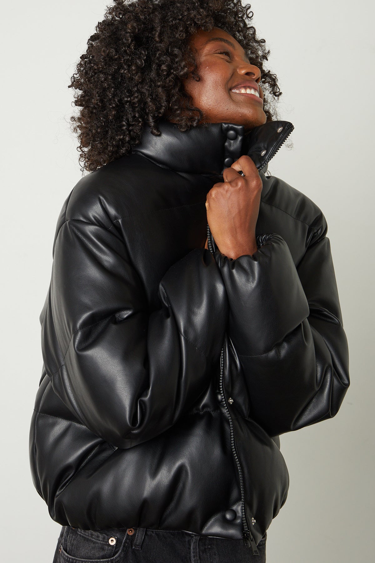   Ally Faux Leather Puffer Jacket in black front model holding close 