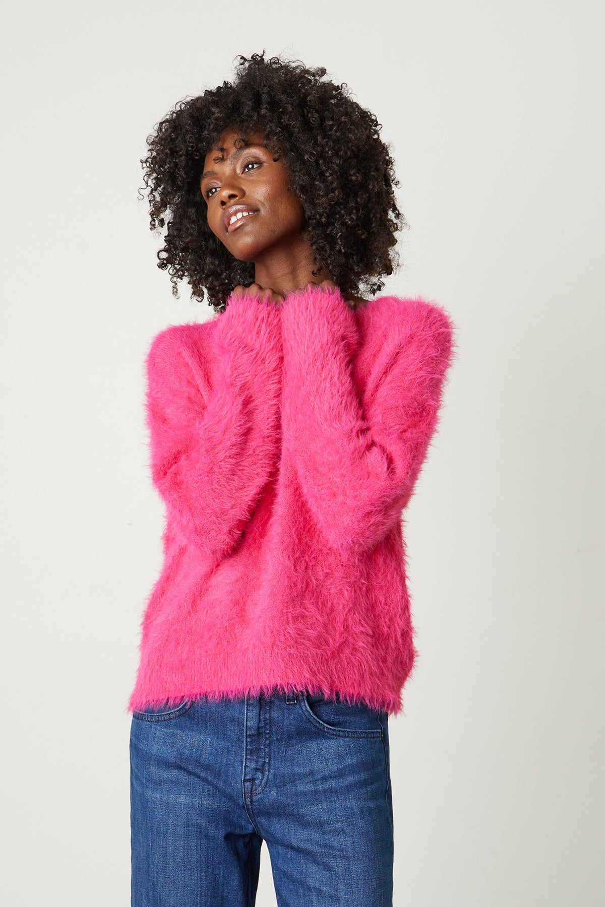 Ray Feather Yarn Crew Neck Sweater in hot pink model standing with hands near chin.-25444377395393
