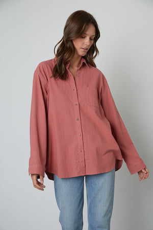 The model is wearing a slightly oversized Chelsey Button-Up Shirt made by Velvet by Graham & Spencer.