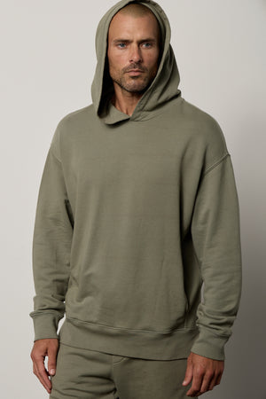 Dan Hoodie in camp muted green french terry with hood up paired with Kane short