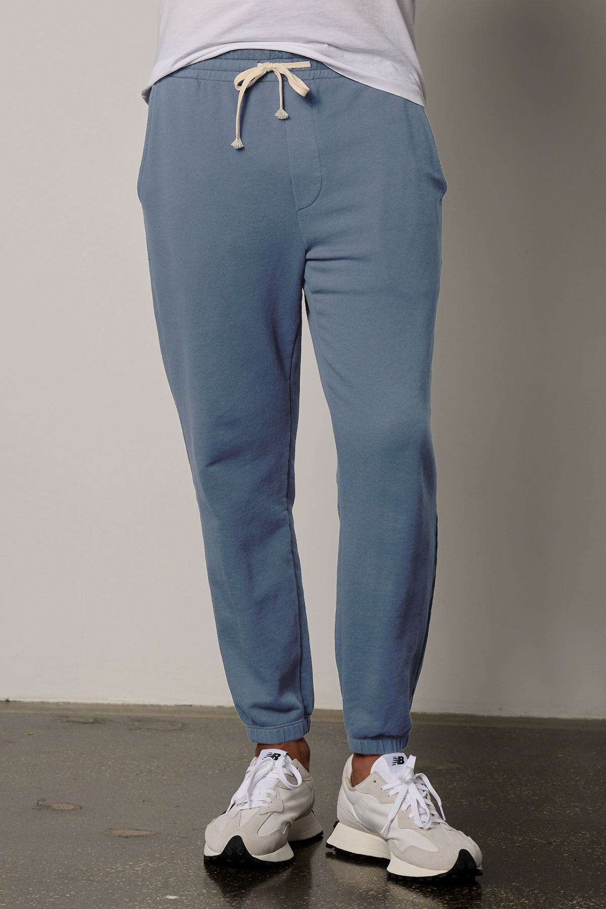 a man wearing Velvet by Graham & Spencer's NELSON FRENCH TERRY JOGGER sweatpants and a white t - shirt.-26215485014209