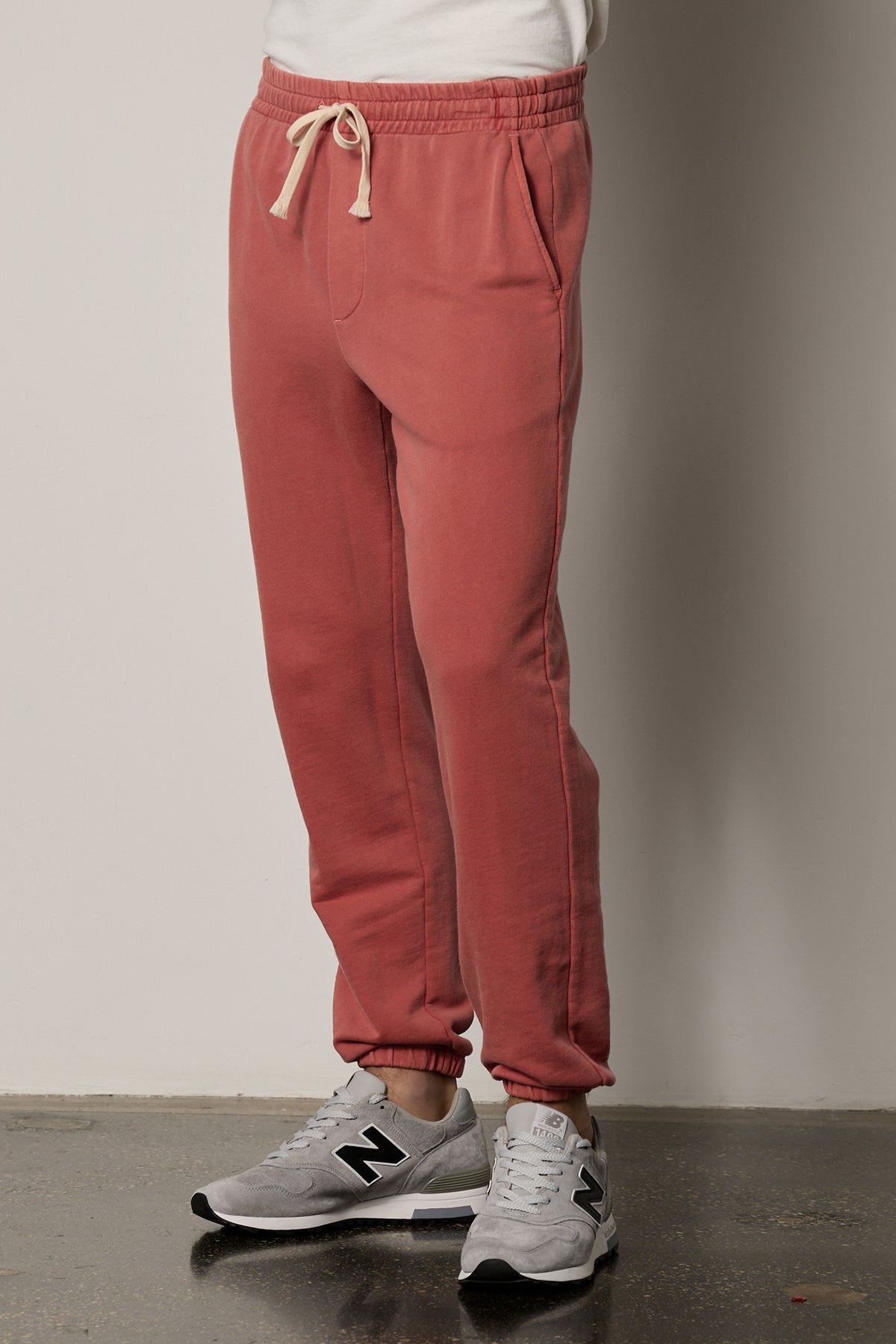   a man wearing the Velvet by Graham & Spencer NELSON FRENCH TERRY JOGGER sweatpants and white sneakers. 