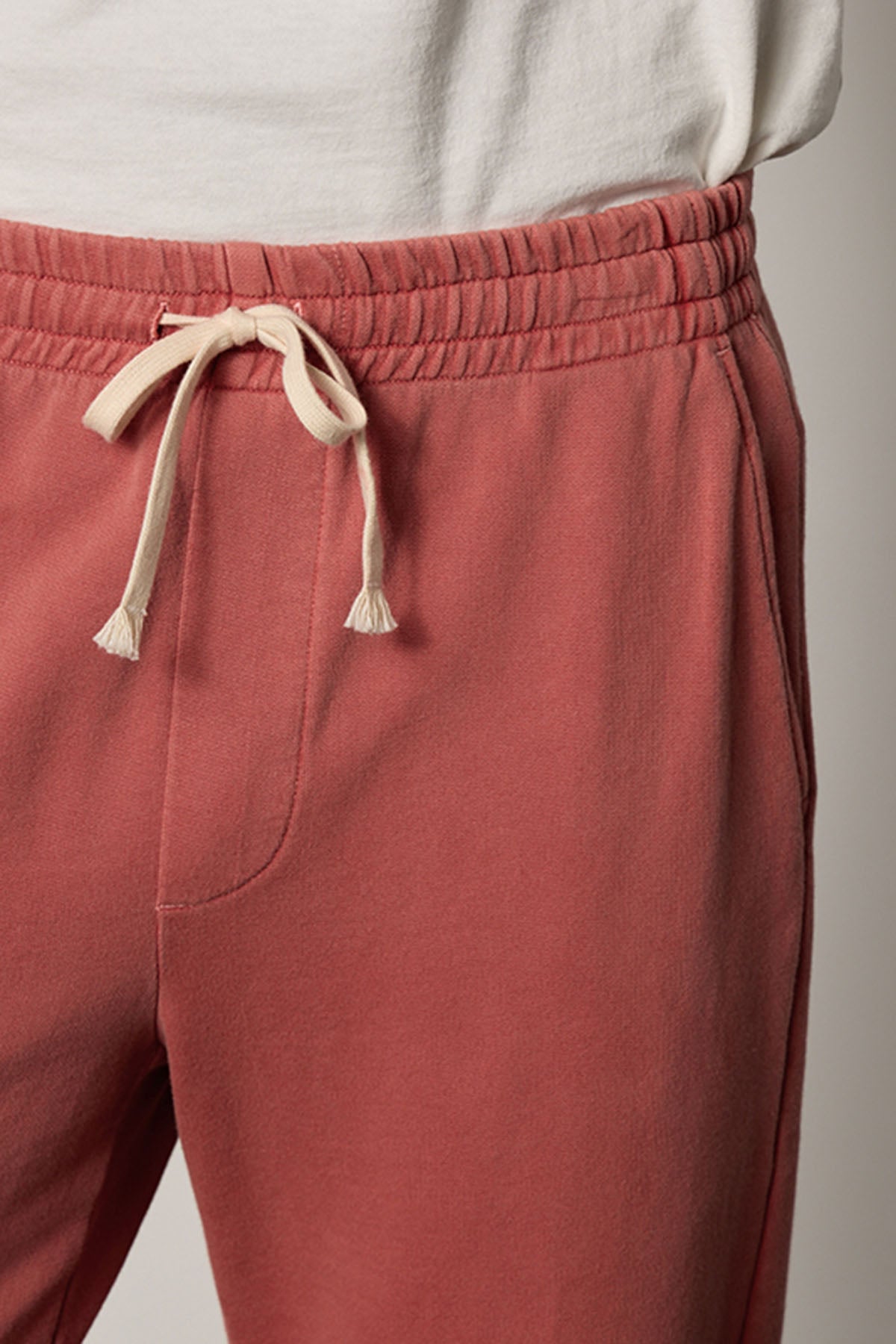 A man wearing a Velvet by Graham & Spencer NELSON FRENCH TERRY JOGGER with white drawstrings.-26207907512513