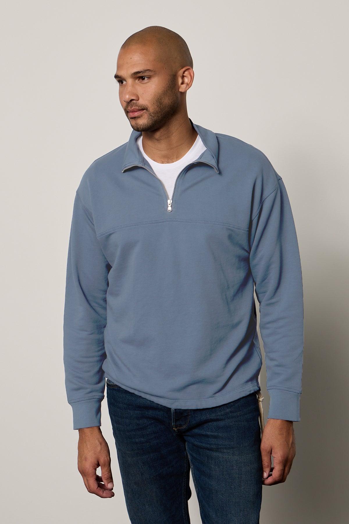 A man wearing a Velvet by Graham & Spencer Patrick Quarter-Zip Sweatshirt made of French Terry.-26207907807425