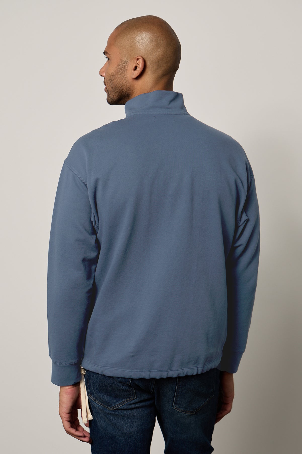   The back view of a man wearing a Velvet by Graham & Spencer Patrick quarter-zip sweatshirt. 