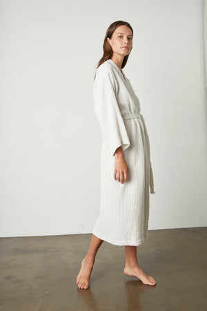 The model is wearing a white COTTON GAUZE ROBE from Jenny Graham Home with a belt.