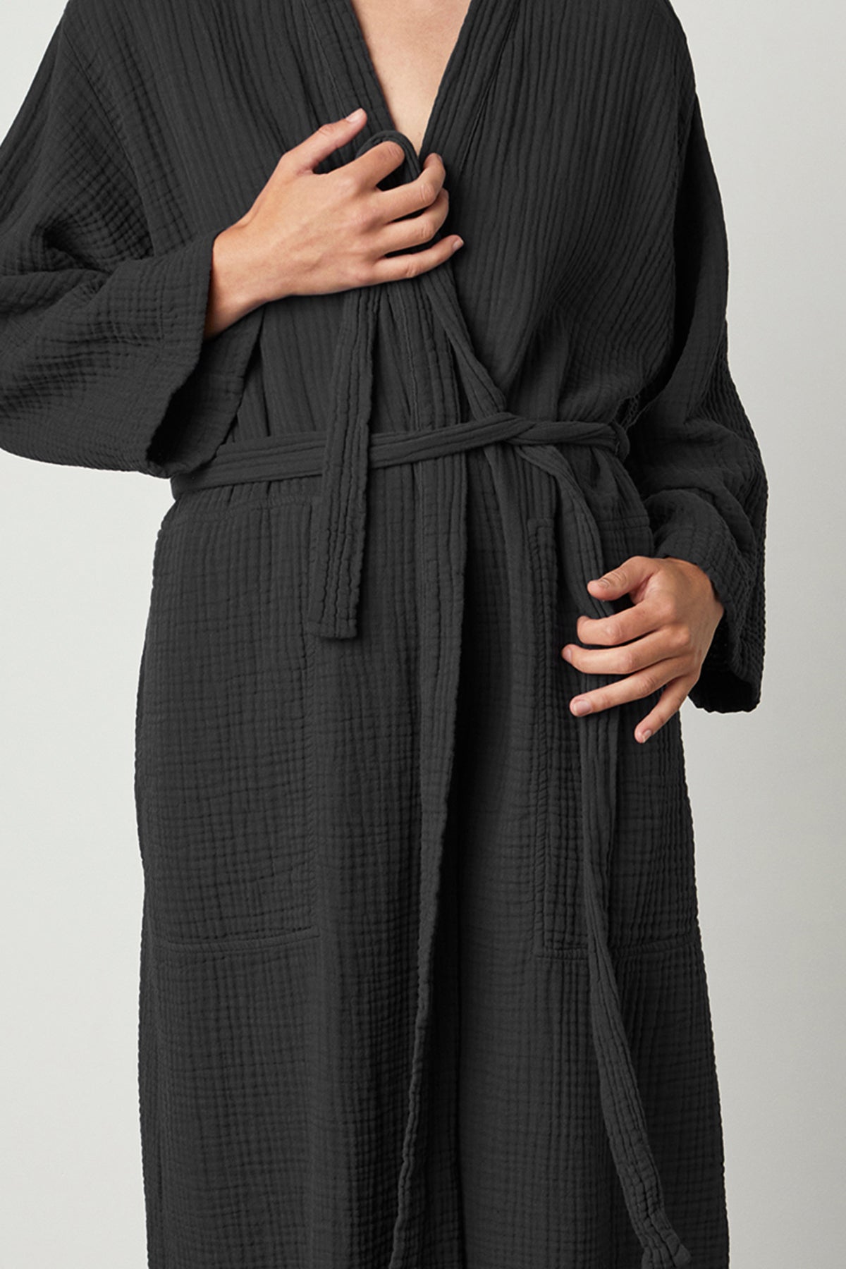 A woman wearing a Jenny Graham Home Cotton Gauze Robe with a belt.-23556219830465