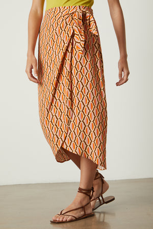 Alisha skirt in orange geometric pattern with sandals front & side