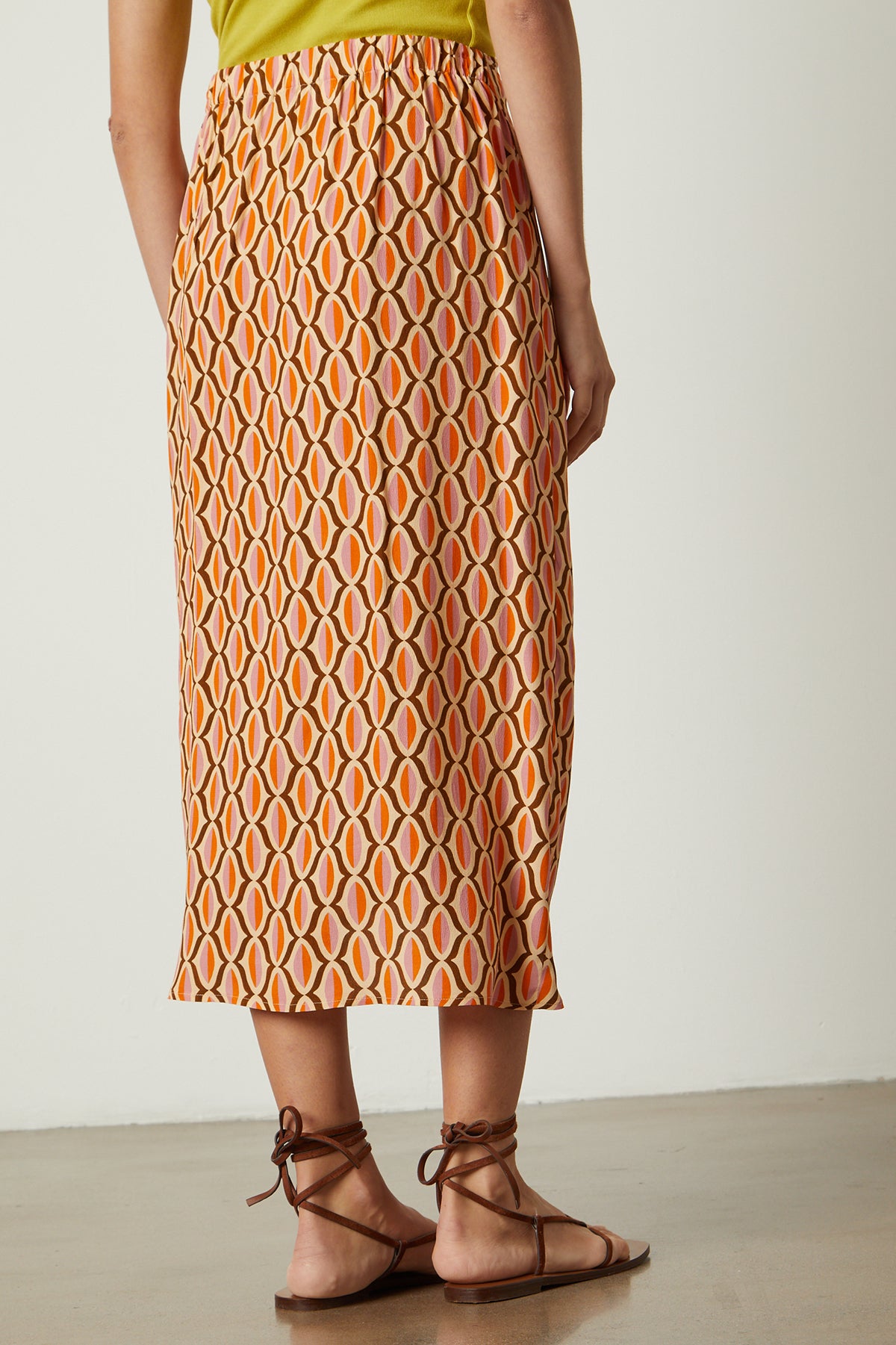   Alisha skirt in orange geometric pattern with sandals back 