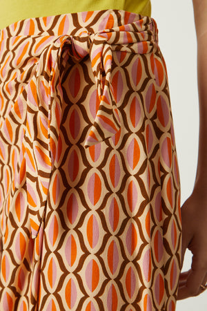 Alisha skirt in orange geometric pattern front wrap detail