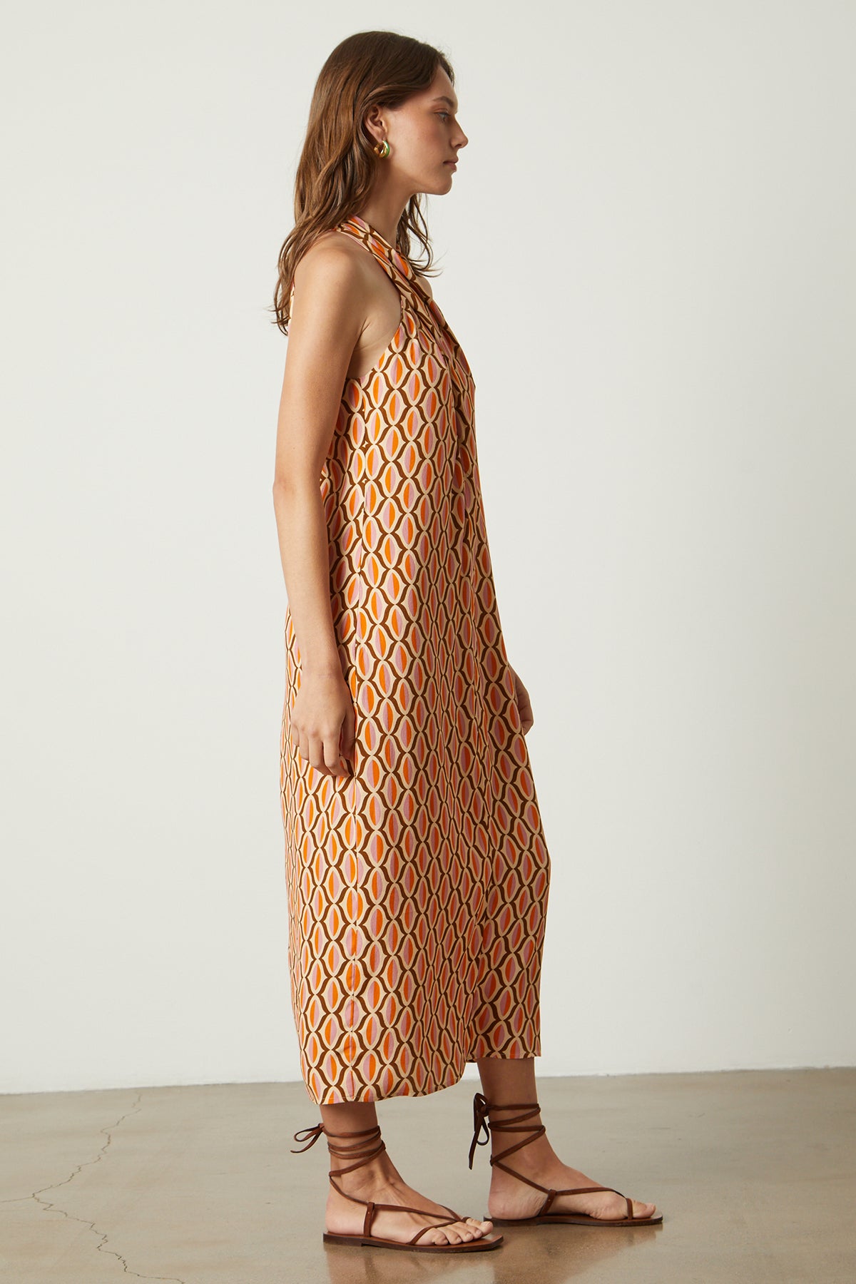 Caterina dress in orange geometric pattern gold earrings and sandals side-26079027069121