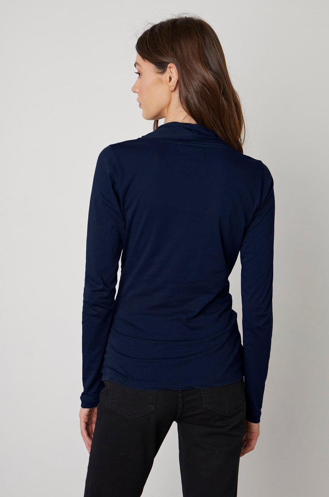the back view of a woman wearing a Velvet by Graham & Spencer MERI WRAP FRONT FITTED TOP.-23013992890561