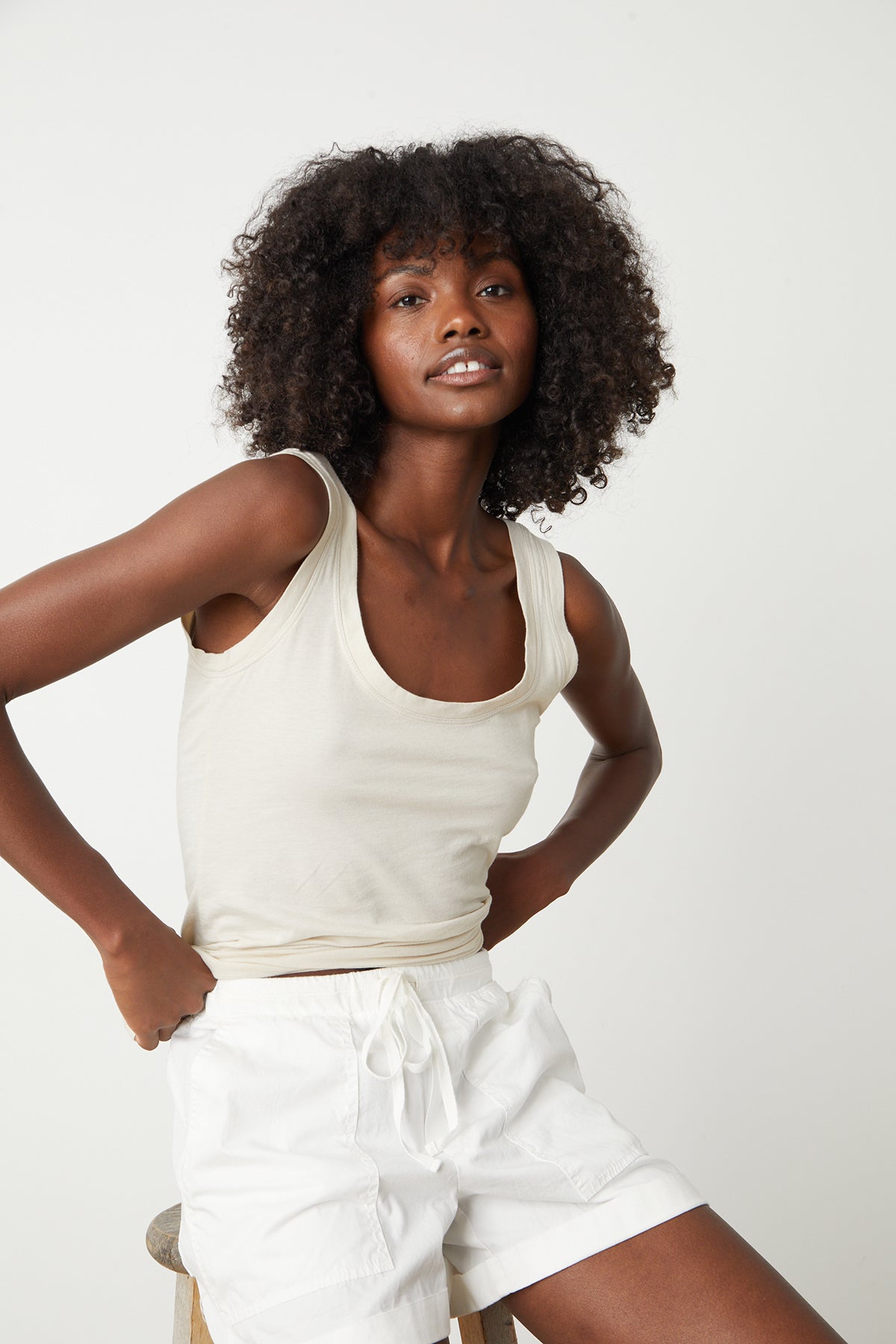   A woman wearing a white Velvet by Graham & Spencer Tenley Cotton Twill Short and white shorts. 