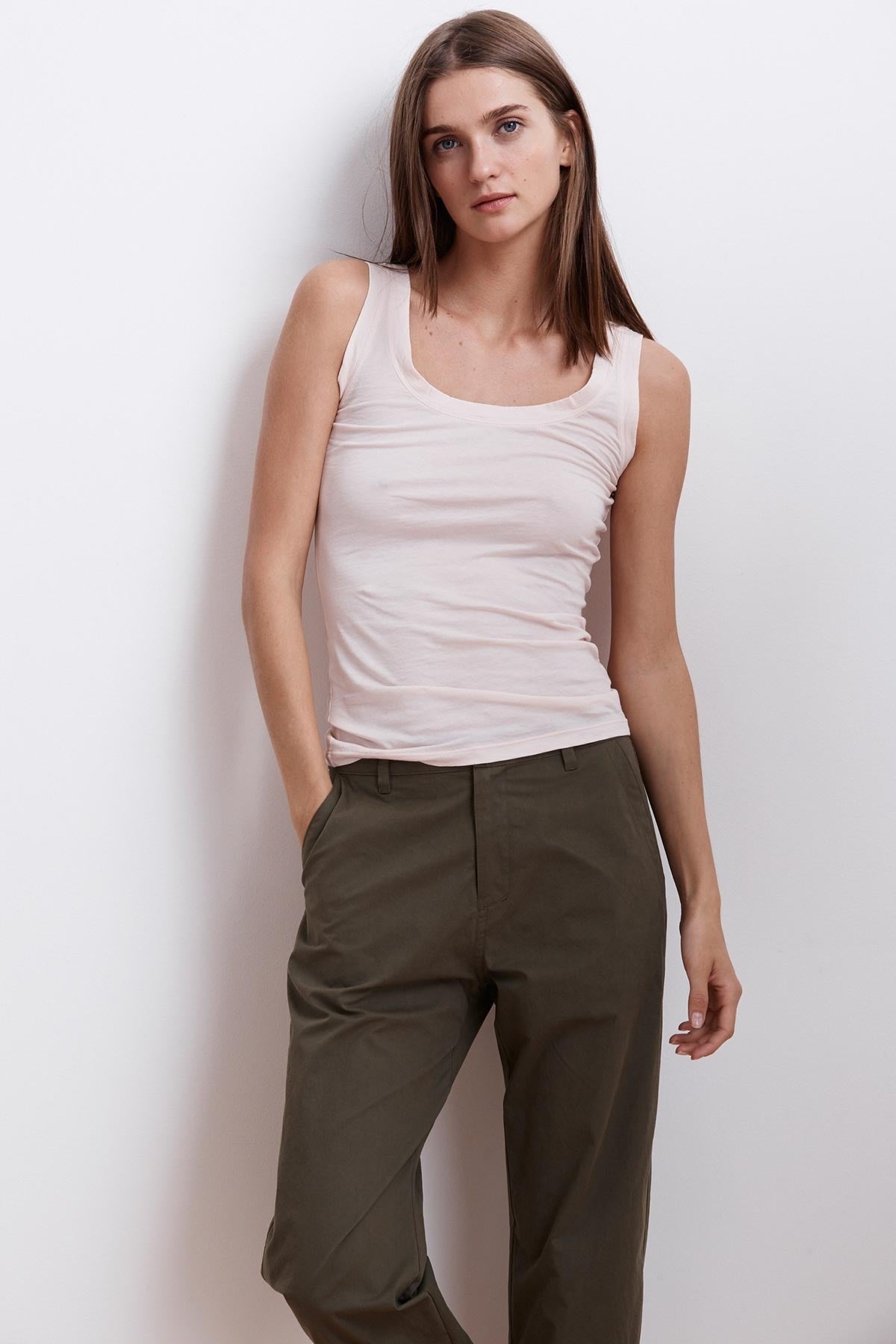 A woman wearing a Velvet by Graham & Spencer MOSSY GAUZY WHISPER FITTED TANK tank top.-23854475444417