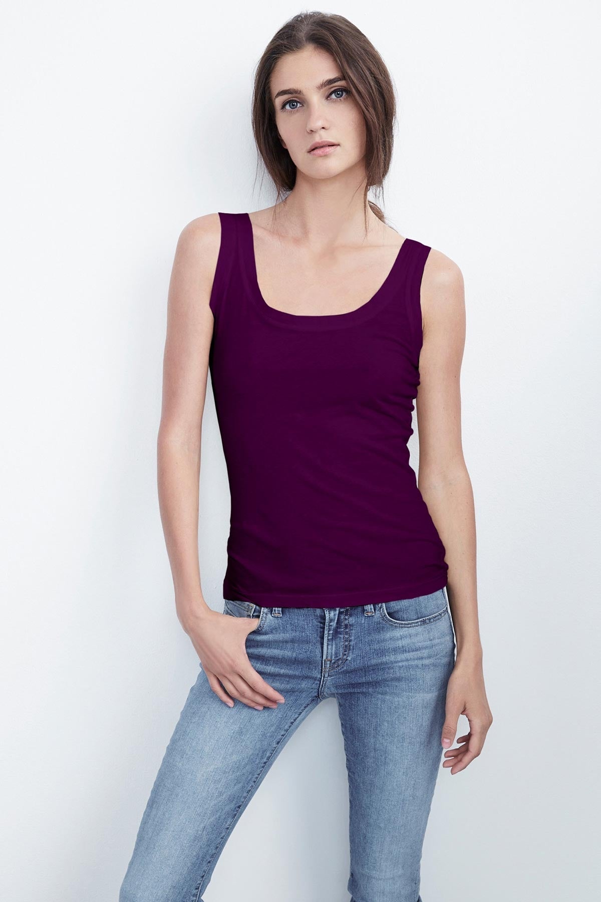 A woman wearing a MOSSY GAUZY WHISPER FITTED TANK by Velvet by Graham & Spencer and jeans.-23854475280577