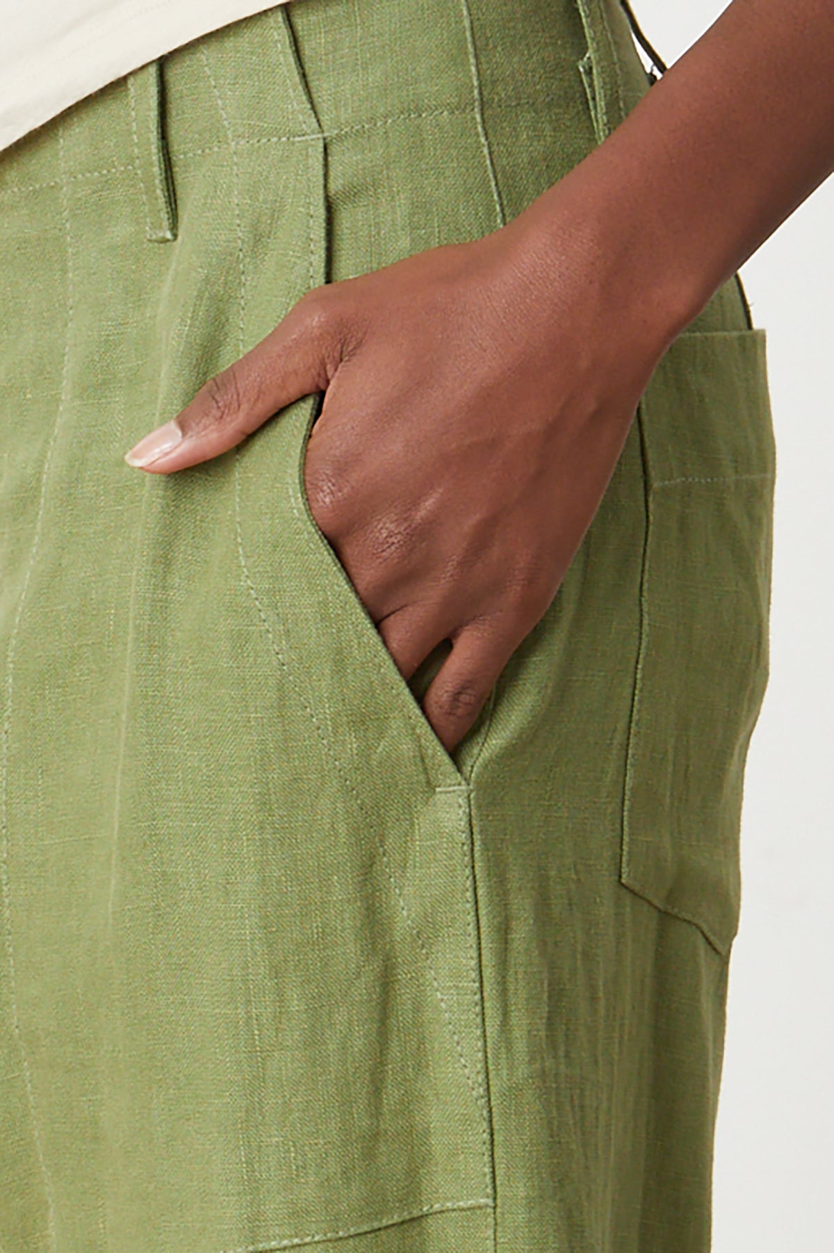   Dru Pant in basil green heavy linen close pocket detail with model's hand in pocket 
