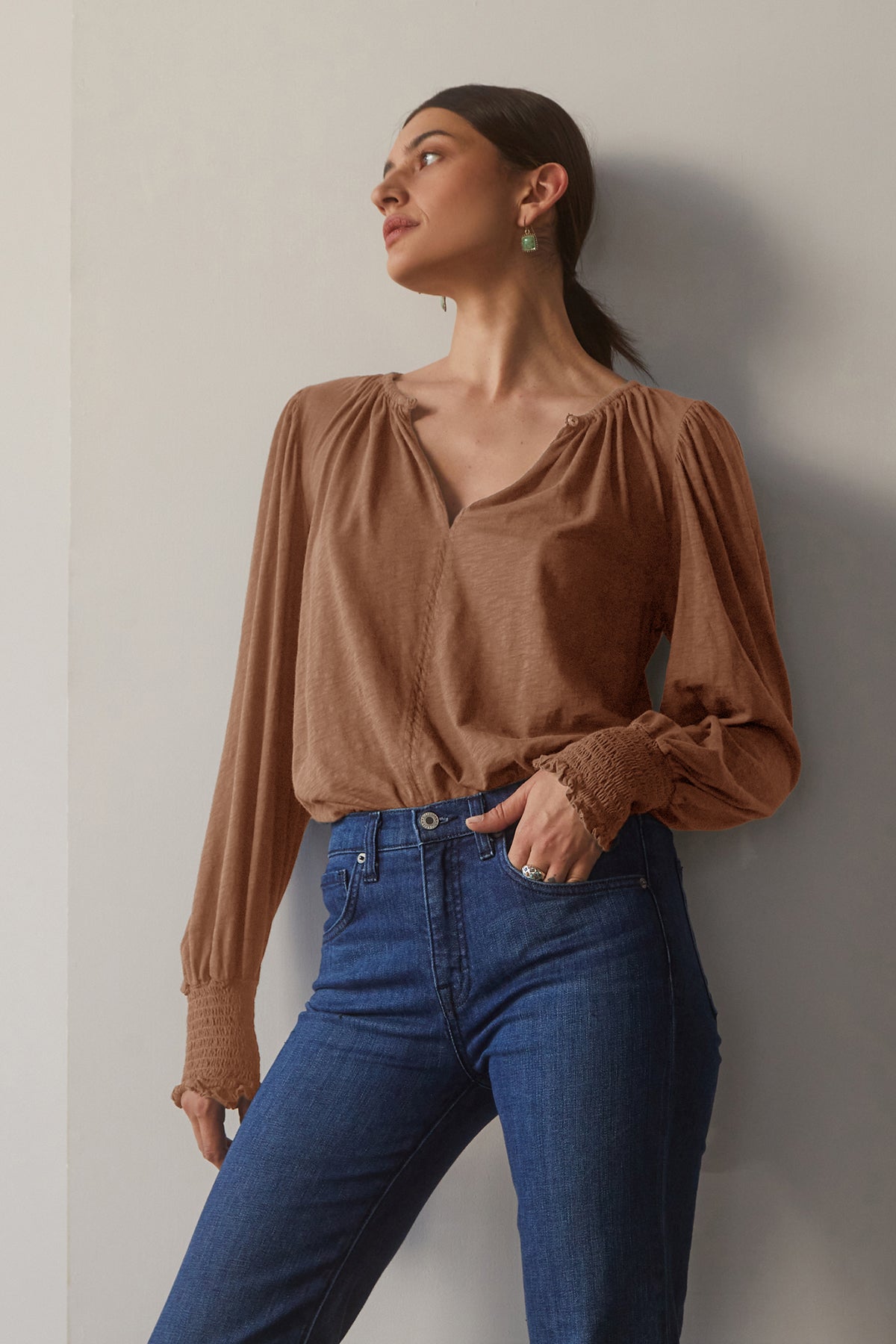   A bohemian chic woman wearing Velvet by Graham & Spencer cotton slub jeans and a shirred brown blouse. 