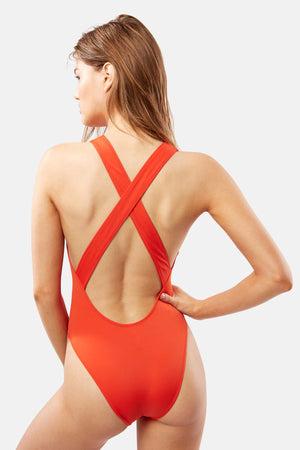 The back view of a woman in a Jackie Criss Cross One Piece swimsuit by Solid & Striped.