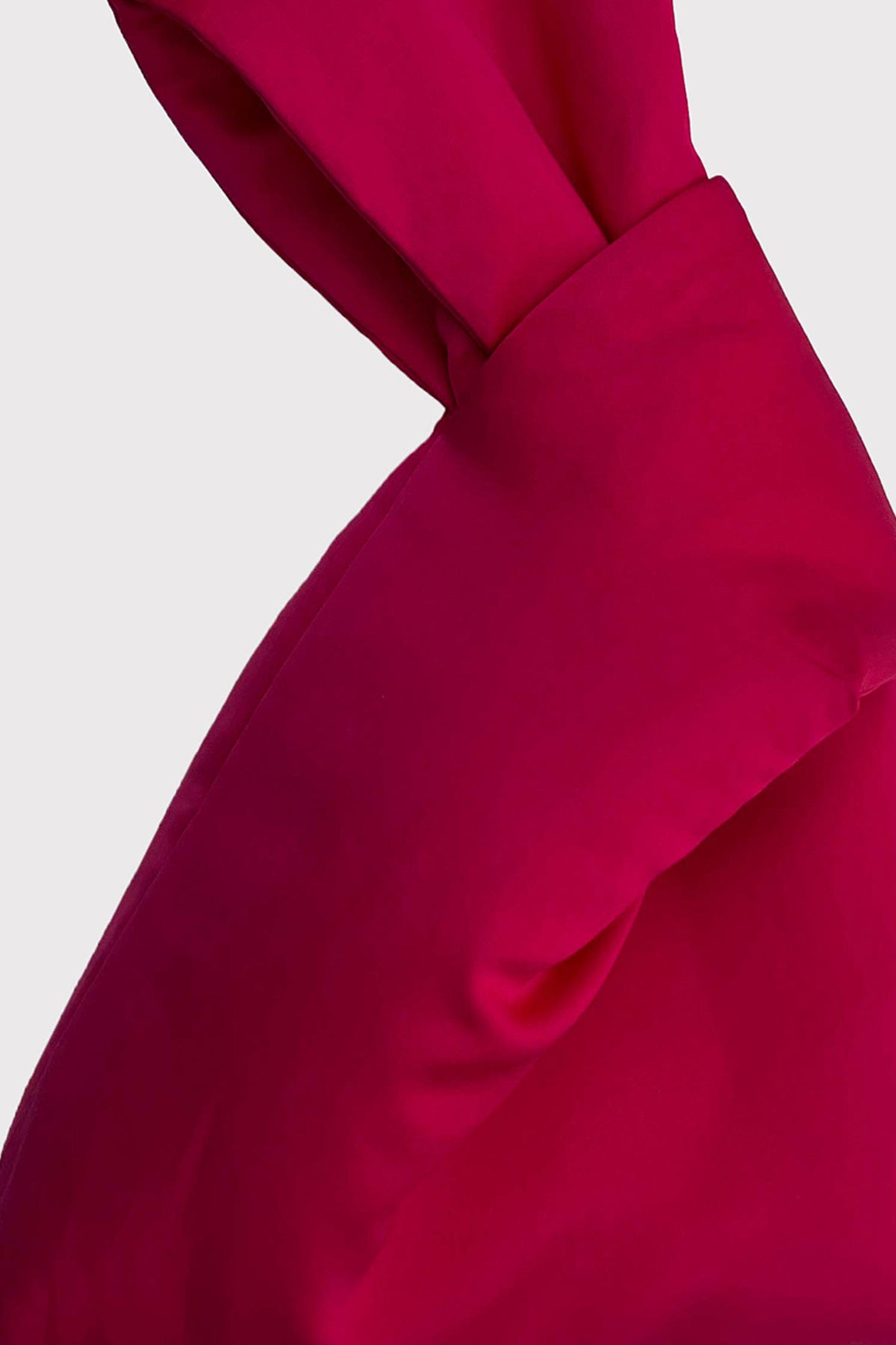   A close up of a Velvet by Jenny Graham fuchsia colored scarf. 
