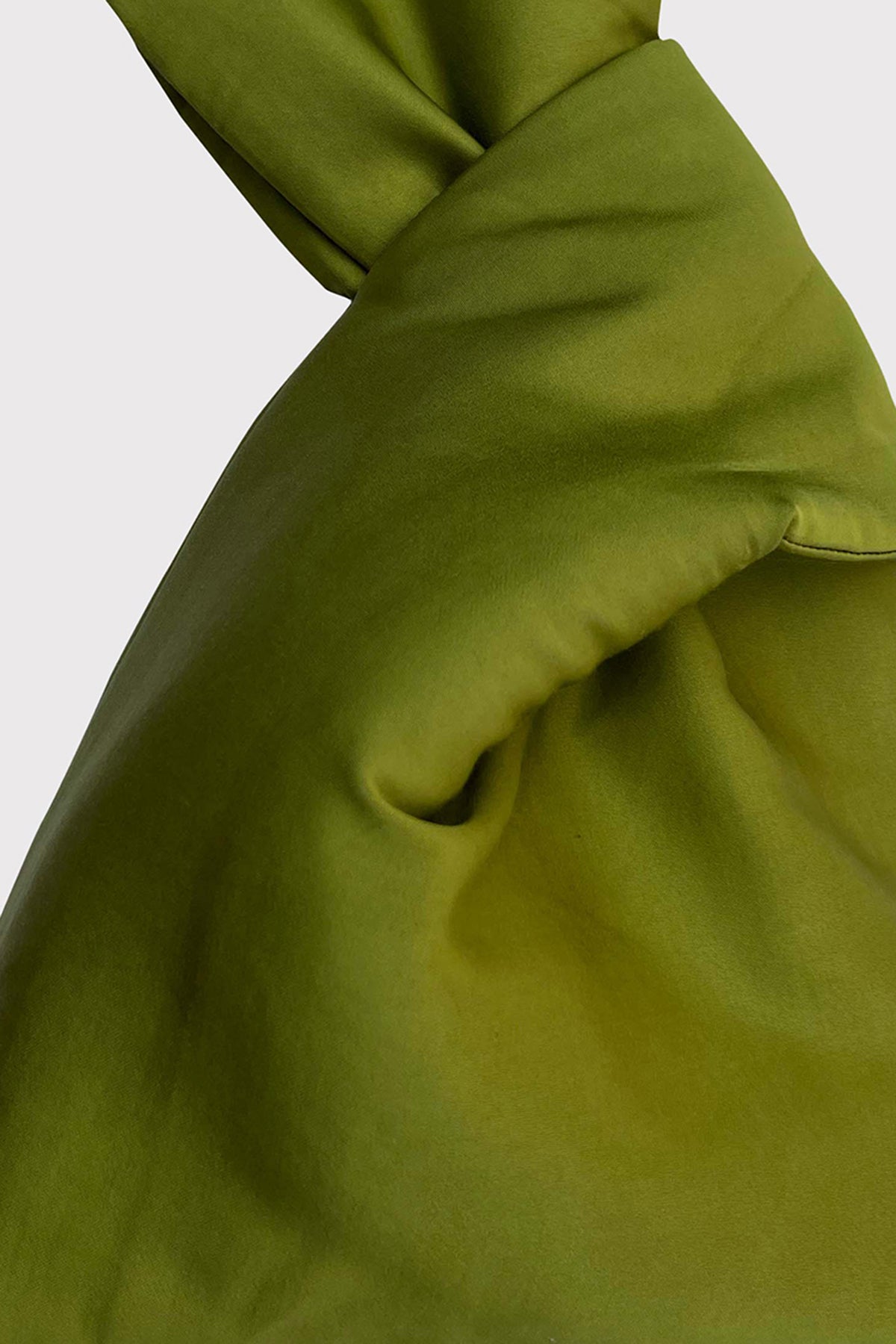   A close up of a green Velvet by Jenny Graham silk scarf. 