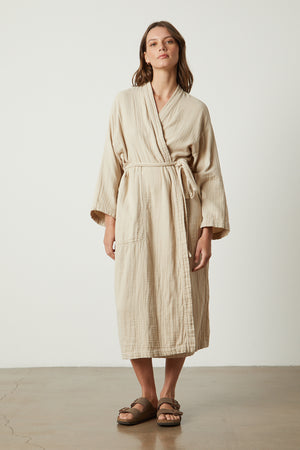 a woman wearing a Jenny Graham Home Cotton Gauze Robe and sandals.