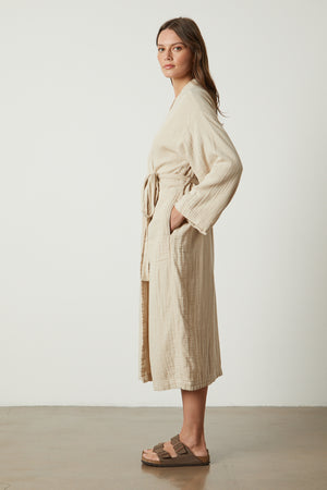 a model wearing a Jenny Graham Home COTTON GAUZE ROBE and sandals.